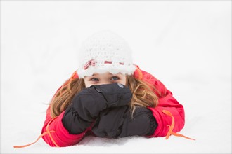 Portrait of girl (2-3) lying on snow