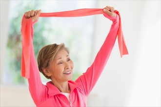 Senior woman exercising with exercise band.