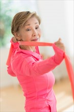 Senior woman exercising with exercise band.