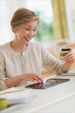 Senior woman shopping online with tablet pc.