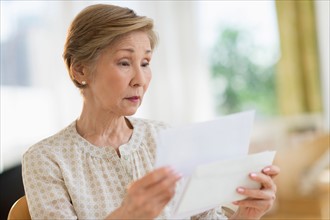Senior woman reading letter.