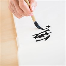 Female hand and japanese calligraphy.