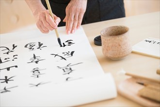Female hands and japanese calligraphy.