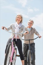 Senior couple riding bicycle.