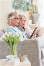 Senior couple paying bills via internet.