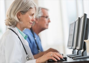 Female and male doctors working at computers.