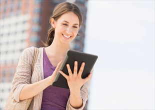 Young female using digital tablet.