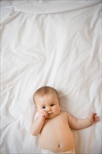 Portrait of baby girl (6-11 months) lying down
