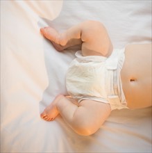Low section of baby girl (6-11 months) lying down