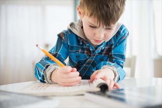 Portrait of boy (4-5) writing with pencil