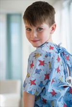 Portrait of boy (4-5) in surgical gown