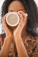 Portrait of woman drinking from coffee mug
