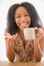 Portrait of happy woman holding coffee cup