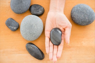 Close up of woman's hand holding pebble