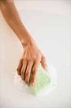 Close up of woman's hand cleaning with sponge
