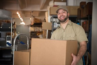 Portrait of delivery man in warehouse