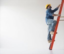 Man climbing up ladder