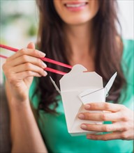 Portrait of woman eating take out food