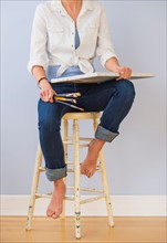 Studio Shot, Low section of woman sitting on stool