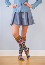Studio Shot of woman wearing skirt and striped kneesocks