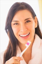 Portrait of woman brushing her teeth