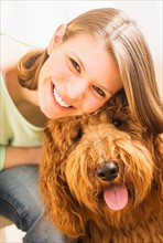 Young cheerful woman with her dog