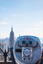 Coin operated binoculars with Empire State Building in background