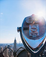 Coin operated binoculars with Empire State Building in background