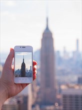 Tourist taking photo of Empire State Building