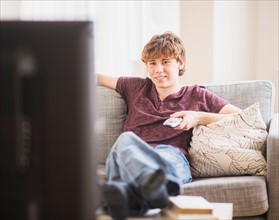 Teenage boy (14-15) watching tv