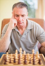 Portrait of man concentrating during chess game