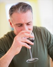 Portrait of man drinking red wine