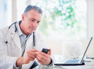 Portrait of doctor using mobile phone