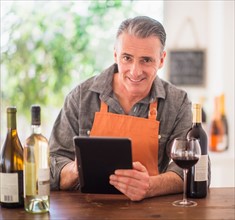 Portrait of restaurant owner using digital tablet