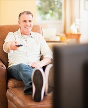 Portrait of man watching tv