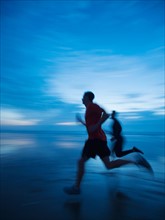 Man running along beach