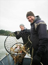 Men showing crabs in net