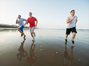 Men running on beach