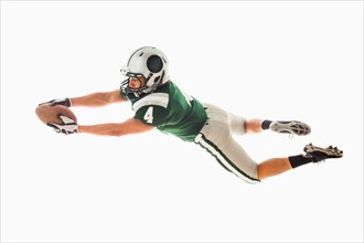 Portrait of American football player catching ball