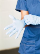 Close-up of nurses hands-putting on surgical gloves