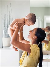 Mother preparing to give her son (2-5 months) bath