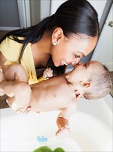 Mother giving her son (2-5 months) a bath