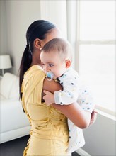 Woman holding her baby son (2-5 months)