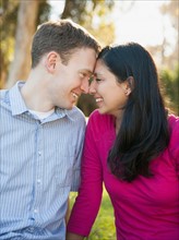 Couple sitting on grass in park