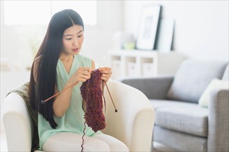 Woman knitting at home.