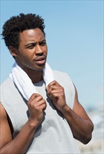 Athlete with towel on neck.