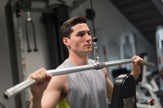 Man exercising in gym.