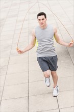 Man exercising with jumping rope.