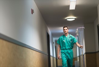 Doctor walking in hospital corridor.