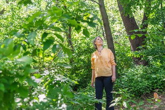 Central Park, New York City. Senior woman hiking in forest.